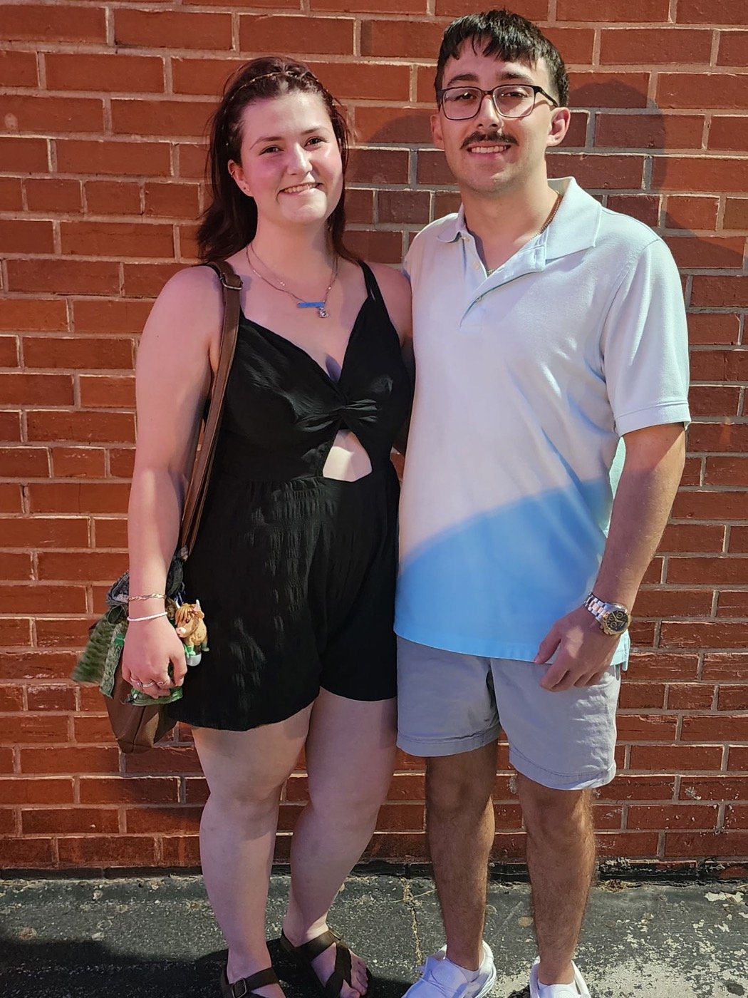 A personal photo shared by Jayden, with two people in front of a brick wall